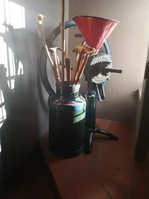 a black vase with toothbrushes in it on a table at A cozy, artistic suburban-stay at Alice in Africa in Rooihuiskraal