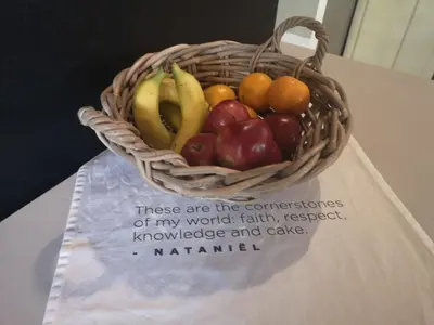 a basket of fruit sitting on a table at A cozy, artistic suburban-stay at Alice in Africa in Rooihuiskraal