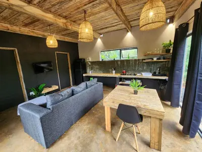 a living room with a couch and a table at Hartbeest Bush Stay #26 in Kosmos