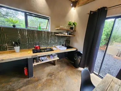 a room with a desk in a room with windows at Hartbeest Bush Stay #26 in Kosmos