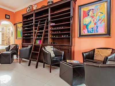a wine tasting room with chairs and a wine rack at Casta Diva Boutique Hotel in Pretoria