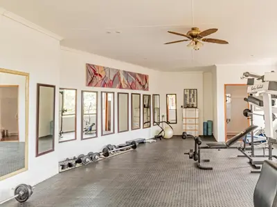 a gym with several treadmills and exercise machines at Casta Diva Boutique Hotel in Pretoria