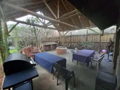 a covered patio with blue tables and chairs and a piano at Leeupoort Bosvakansie in Leeupoort
