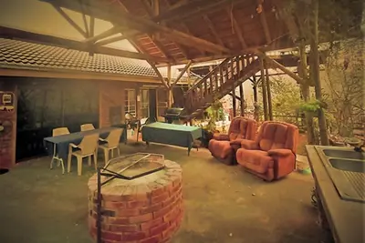 a living room with a table and chairs and a couch at Leeupoort Bosvakansie in Leeupoort