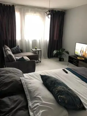 a bedroom with a bed with a pillow on it at Neat, instaworthy, self-checkin flat in Pretoria in Pretoria
