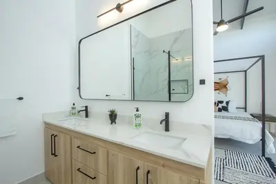 a bathroom with a sink and a mirror at Giraffe Oasis - Kruger Luxury Family Villa in Marloth Park