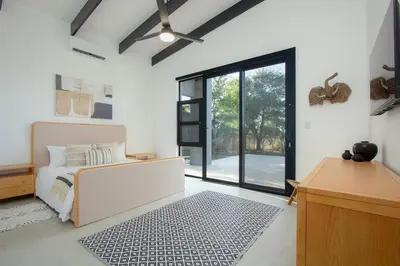 a bedroom with a bed and a large window at Giraffe Oasis - Kruger Luxury Family Villa in Marloth Park
