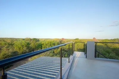 a balcony of a house with a viewing deck at Giraffe Oasis - Kruger Luxury Family Villa in Marloth Park