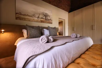 a bedroom with a large bed with towels on it at Senalala Safari Lodge in Klaserie Private Nature Reserve