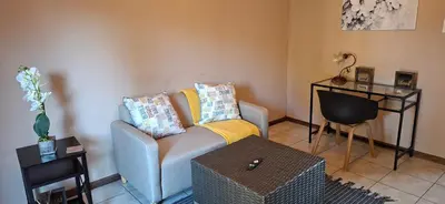 a living room with a couch and a table at 9 on Deimos Ave in Polokwane