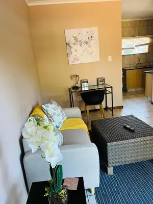a living room with a couch and a table at 9 on Deimos Ave in Polokwane