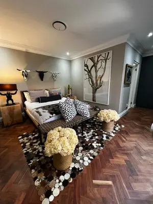 a living room with a couch and flowers at Pecanwood Exclusive Luxury Villa Hartbeesport Dam in Hartbeespoort