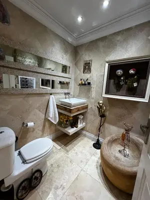 a bathroom with a toilet and a sink at Pecanwood Exclusive Luxury Villa Hartbeesport Dam in Hartbeespoort
