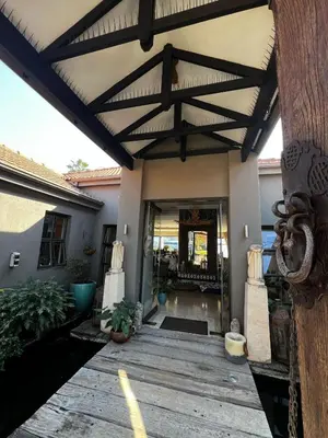 a house with a wooden porch with awning at Pecanwood Exclusive Luxury Villa Hartbeesport Dam in Hartbeespoort