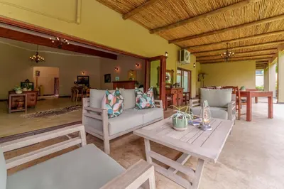 a living room with a couch and a table at Lion Tree Top Lodge in Guernsey Nature Reserve