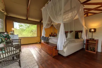 a bedroom with a canopy bed in a room at Lion Tree Top Lodge in Guernsey Nature Reserve