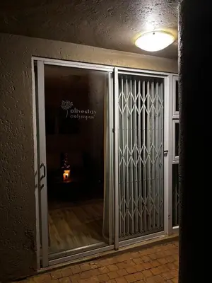 an entrance to a room with a glass door at Olivestay at Olympus - Apartment in Pretoria