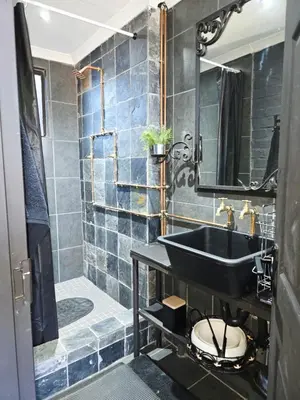 a bathroom with a black sink and a shower at The View in Pretoria