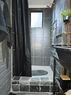 a bathroom with a shower and a sink at The View in Pretoria