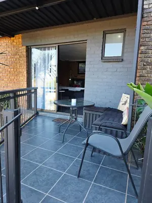 a patio with a table and chairs on a balcony at The View in Pretoria