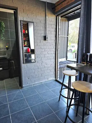 a restaurant with tables and chairs and a brick wall at The View in Pretoria