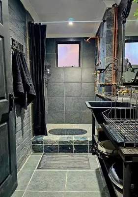 a bathroom with a shower and a sink at The View in Pretoria