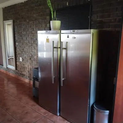 a stainless steel refrigerator with a plant on top of it at Melkbos Place in Witbank