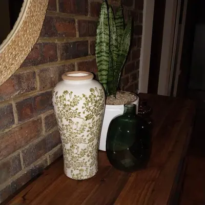 two vases sitting on a wooden table with a plant at Melkbos Place in Witbank
