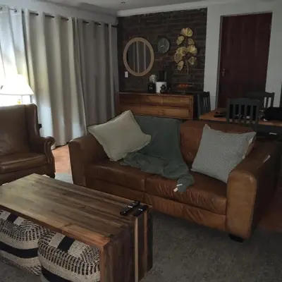 a living room with a couch and a coffee table at Melkbos Place in Witbank