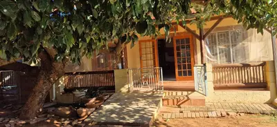 a house with a tree in front of it at Tranquil, Home Away from Home in Pretoria