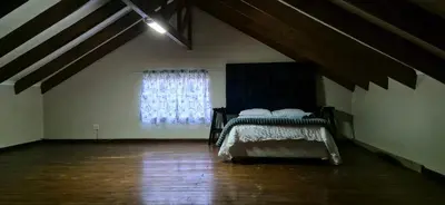 a bedroom with a bed and a window at Tranquil, Home Away from Home in Pretoria