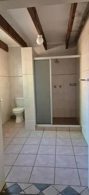 a bathroom with a shower and a toilet in it at Tranquil, Home Away from Home in Pretoria