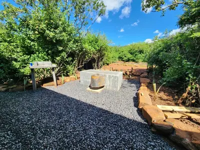 a stone bench sitting on top of a pile of gravel at Hartbeest Bush Stay #28 in Hartbeespoort