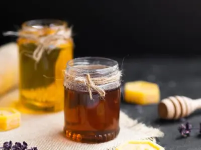 two jars of honey and lemons on a table at Strong Spells To Fix Relationship Problem in Polokwane