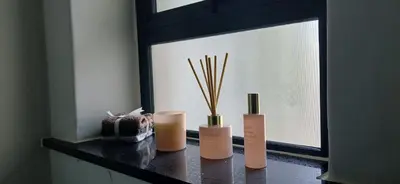three vases sitting on a counter in a window at Munyaka in Midrand