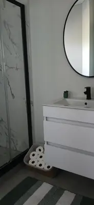 a bathroom with a sink and a shower with a mirror at Munyaka in Midrand