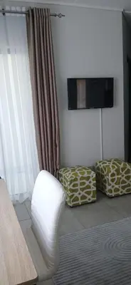 a living room with a couch and a chair at Munyaka in Midrand
