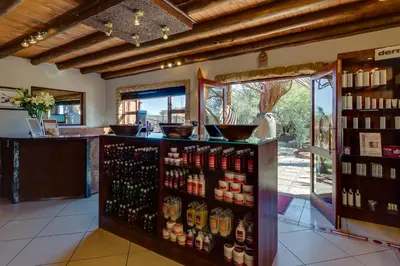 a store with a lot of bottles of alcohol at Zebula Golf Estate & Spa Executive Holiday Homes in Mabula