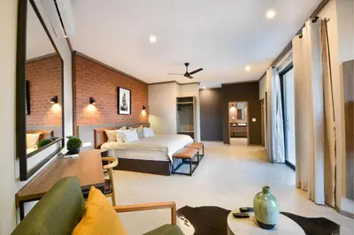 a hotel room with a bed and a couch at Zebula Golf Estate & Spa Executive Holiday Homes in Mabula