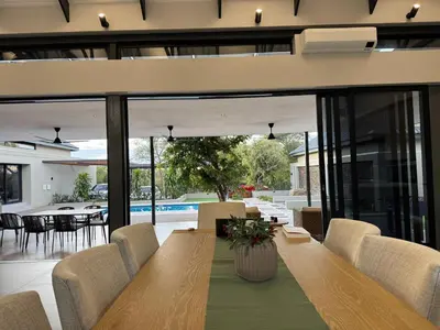 a dining room with a table and chairs at blydebushvilla in Hoedspruit