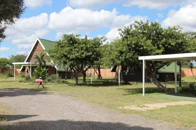 a person playing frisbee in front of a house at Aurora Village in Polokwane