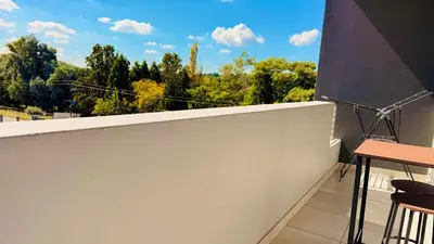 a balcony with a view of trees and clouds at HeartWood Haven in Midrand