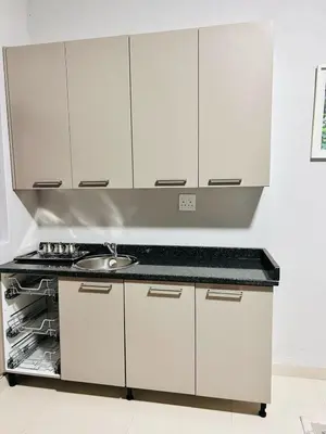 a kitchen with white cabinets and a sink at Tranquil Acres in Nelspruit