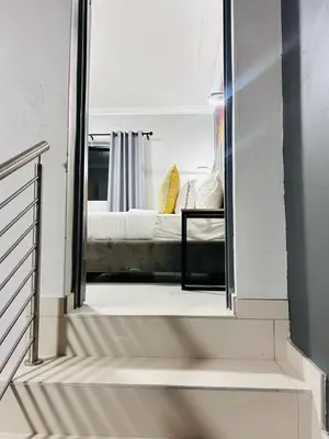 a view of a bedroom through a mirror at Tranquil Acres in Nelspruit
