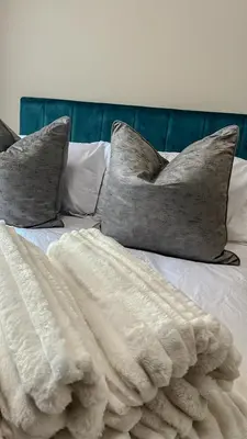 a bed with two pillows and a blanket on it at The Ridge Modern Escape in Midrand