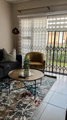 a living room with a couch and a coffee table at The Ridge Modern Escape in Midrand