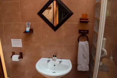 a bathroom with a sink and a mirror at 18 Churchill Avenue in Witbank