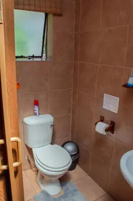 a bathroom with a toilet and a sink at 18 Churchill Avenue in Witbank