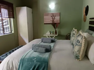 a bedroom with a large bed with two pillows on it at Kifaru - Kruger in Marloth Park