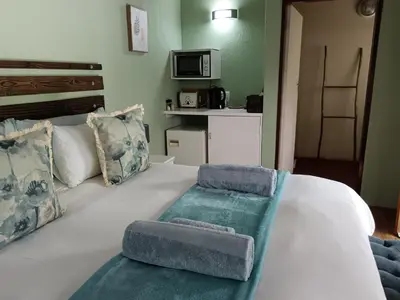 a large white bed with two pillows on it at Kifaru - Kruger in Marloth Park